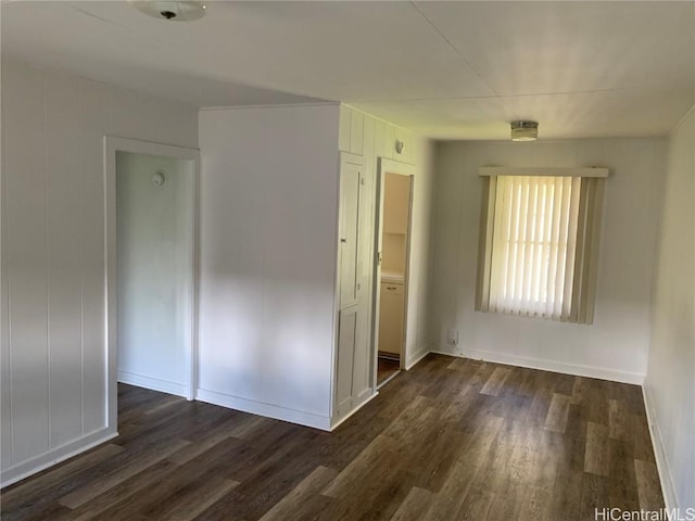 unfurnished room with dark hardwood / wood-style floors