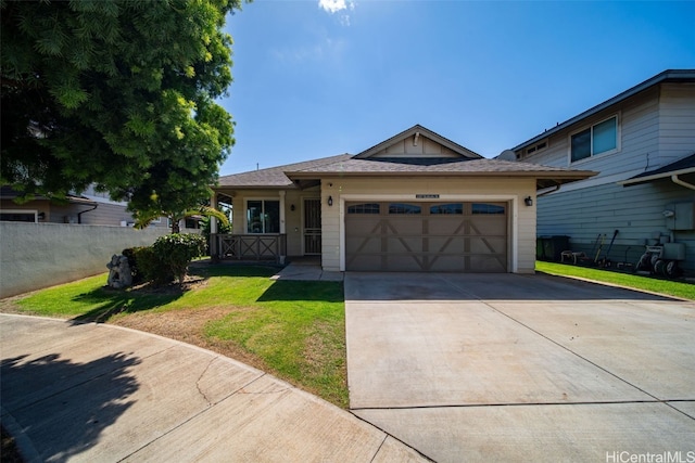 view of front of home featuring a front lawn, concrete driveway, fence, and an attached garage