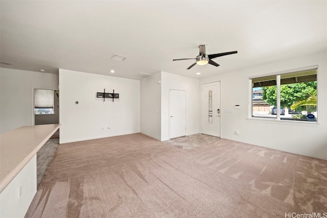 unfurnished living room with a ceiling fan, recessed lighting, and light colored carpet