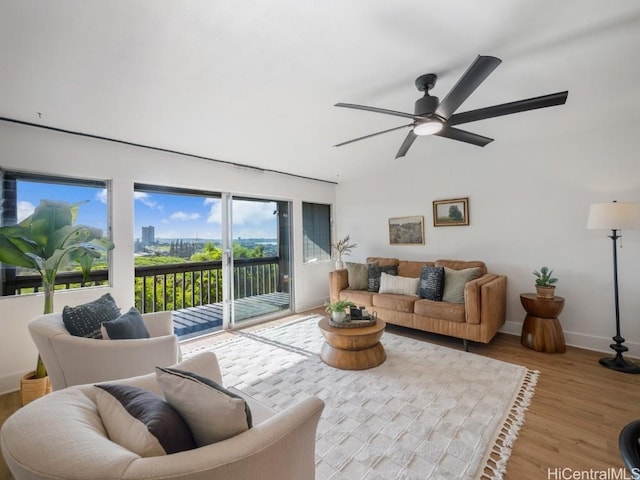 living room with ceiling fan and light hardwood / wood-style flooring