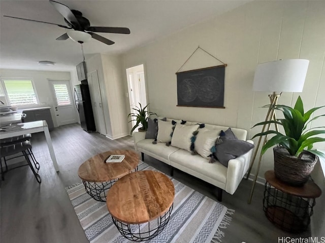 living room featuring ceiling fan and hardwood / wood-style floors