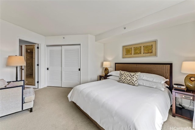 bedroom with light colored carpet and a closet