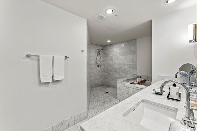 bathroom featuring vanity and tiled shower