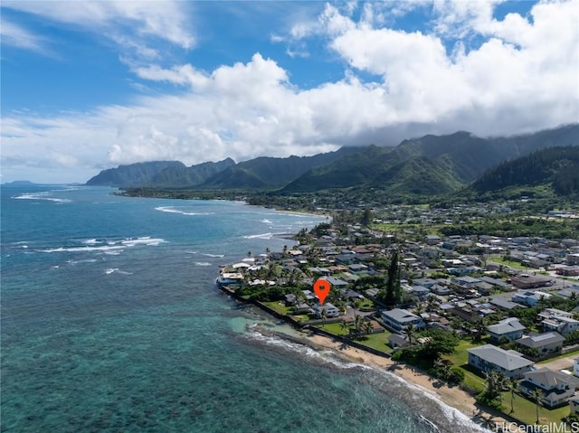 birds eye view of property with a water and mountain view