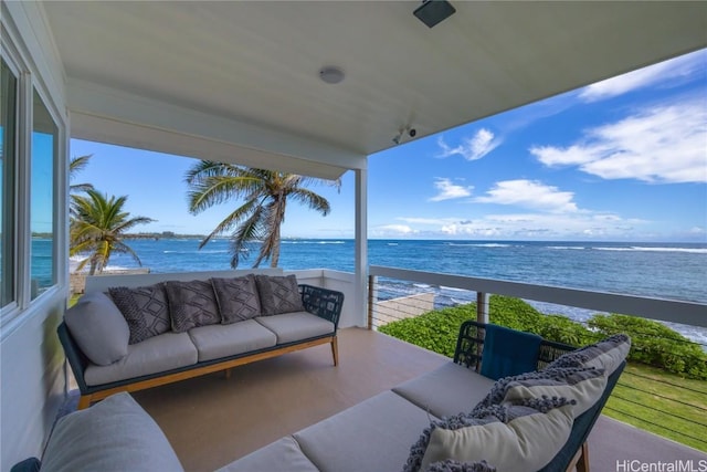 balcony featuring a view of the beach, a water view, and outdoor lounge area