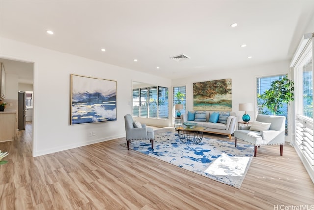 living room with a wealth of natural light and light hardwood / wood-style floors