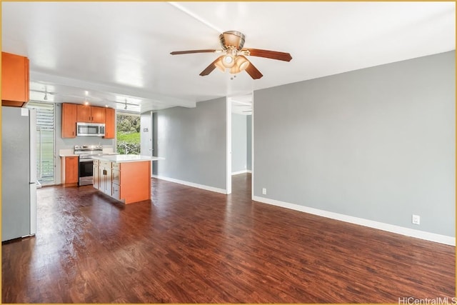 unfurnished living room featuring ceiling fan, track lighting, and dark hardwood / wood-style flooring