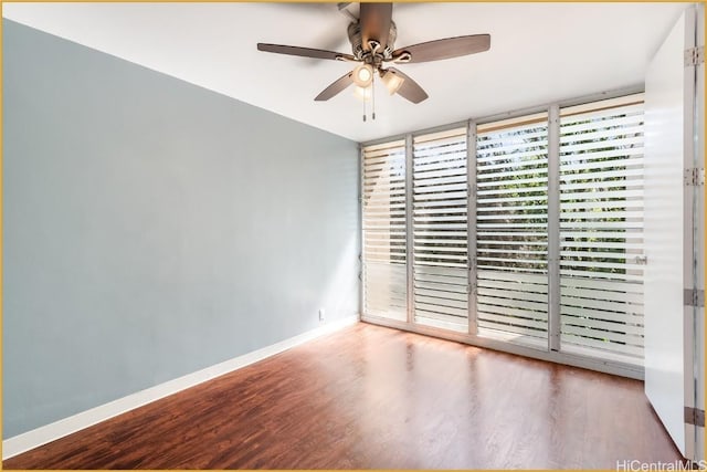 spare room with ceiling fan and wood-type flooring