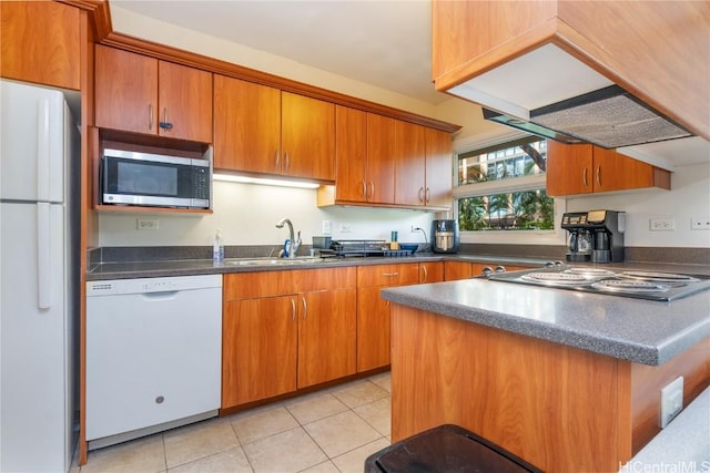 kitchen featuring dark countertops, white appliances, a sink, and light tile patterned flooring