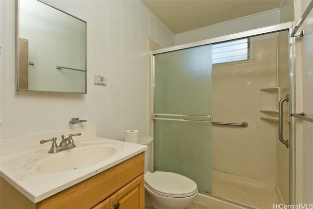 bathroom featuring vanity, walk in shower, and toilet