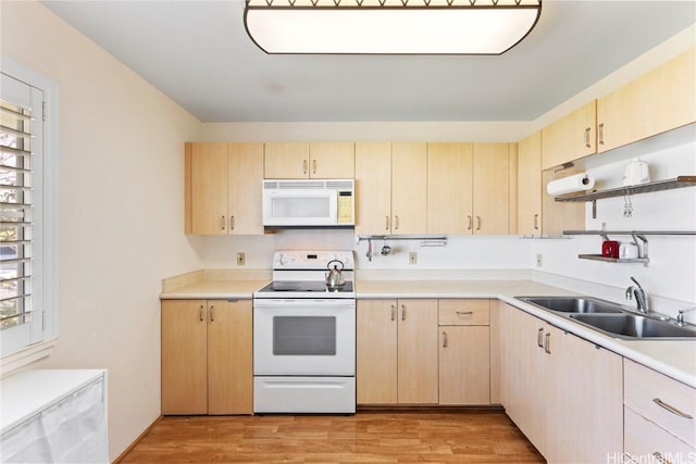 kitchen featuring sink, light brown cabinetry, white appliances, and light hardwood / wood-style flooring