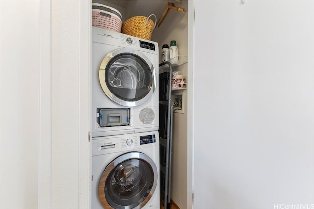 laundry room with stacked washer / dryer