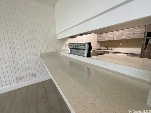 room details with hardwood / wood-style flooring, dishwasher, and sink