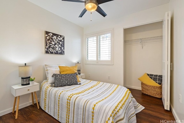 bedroom with baseboards, dark wood finished floors, and a closet