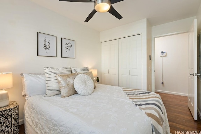 bedroom with dark wood-style floors, a closet, baseboards, and a ceiling fan