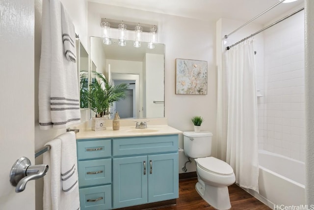 full bathroom with toilet, shower / bath combo with shower curtain, wood finished floors, and vanity