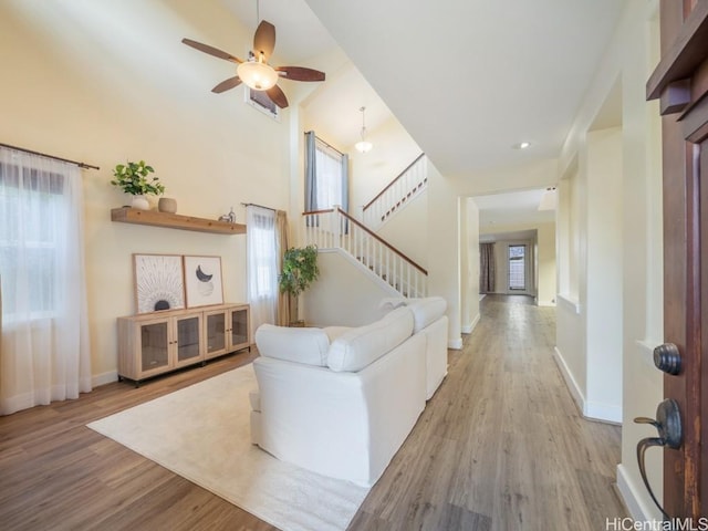 living room featuring light hardwood / wood-style floors and ceiling fan