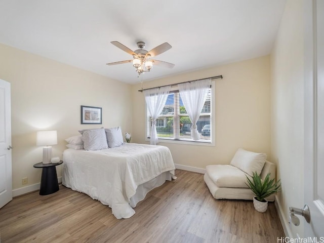 bedroom with ceiling fan and light wood-type flooring