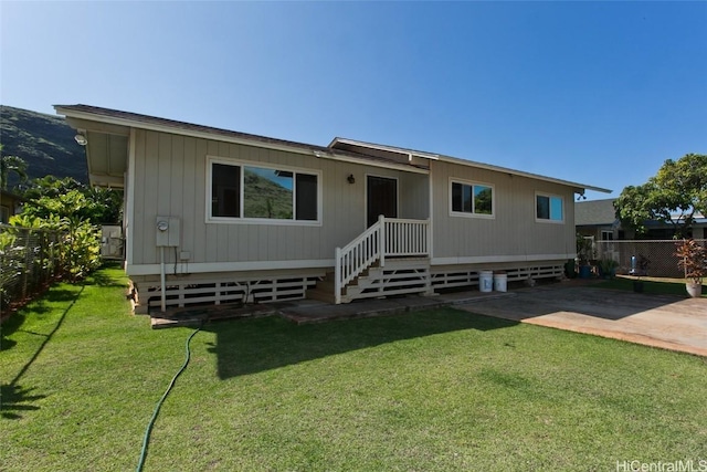 rear view of house with a yard and a patio