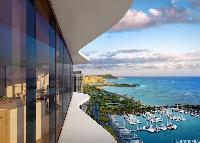 balcony with a water view and a view of city