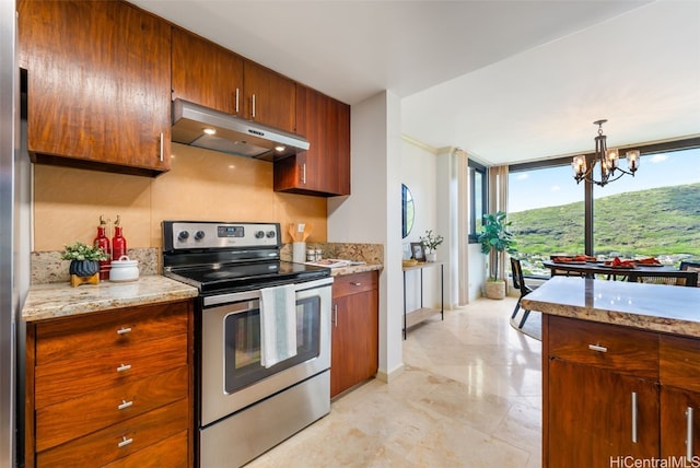 kitchen featuring pendant lighting, a notable chandelier, light stone countertops, and electric range