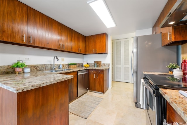 kitchen featuring stainless steel appliances, light stone countertops, and sink