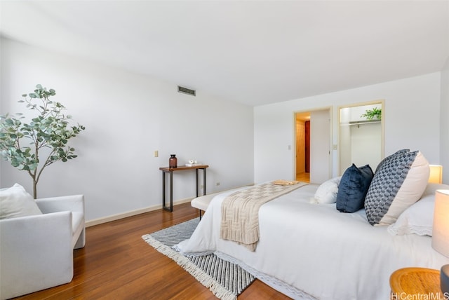 bedroom with dark wood-type flooring