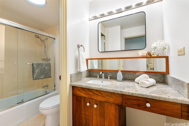 full bathroom with vanity, shower / bath combination with glass door, and toilet