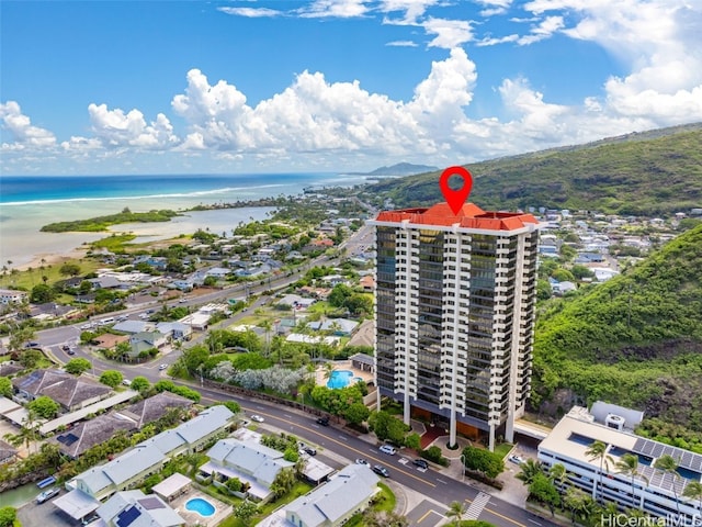 birds eye view of property with a water view and a beach view