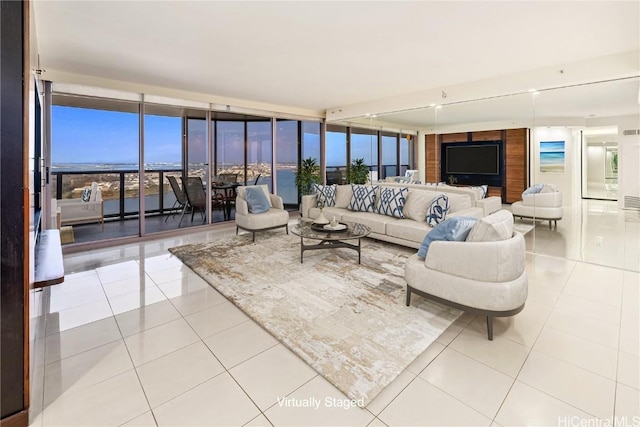 living room featuring a wall of windows and tile patterned floors