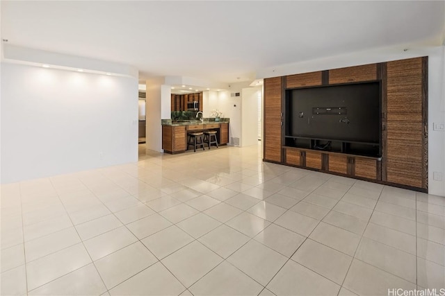 unfurnished living room featuring light tile patterned floors