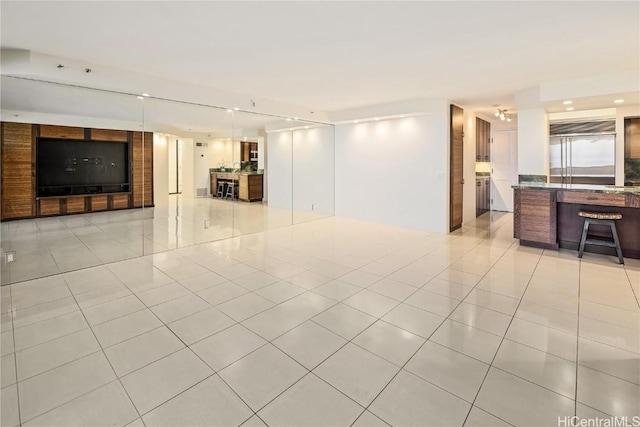 unfurnished living room featuring light tile patterned floors