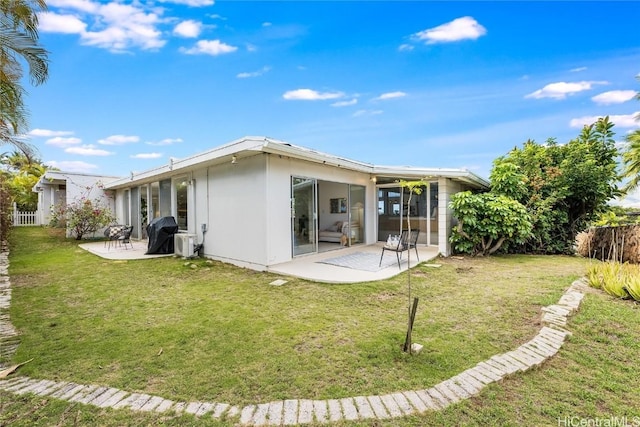 back of property featuring a yard and a patio