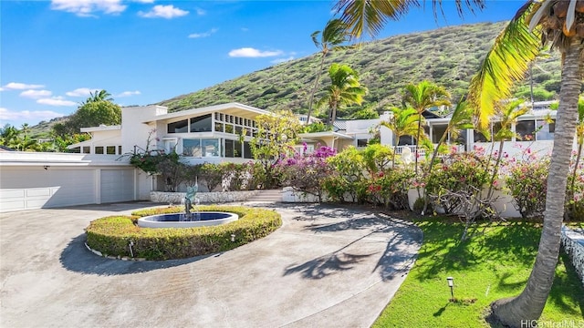 view of front of property featuring a garage and a mountain view