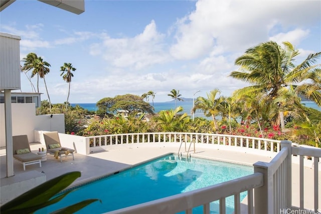 view of pool featuring a water view and a patio area