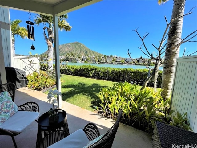 view of patio / terrace featuring a water and mountain view