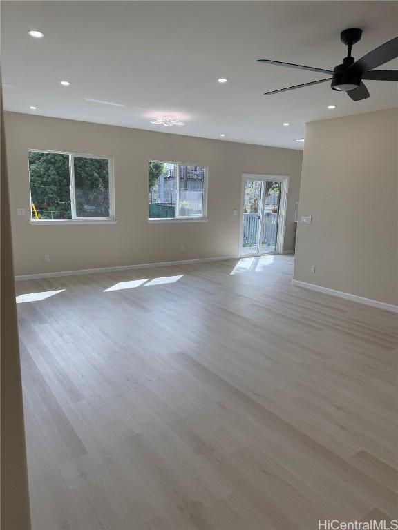 unfurnished room with light wood-style flooring, baseboards, and recessed lighting