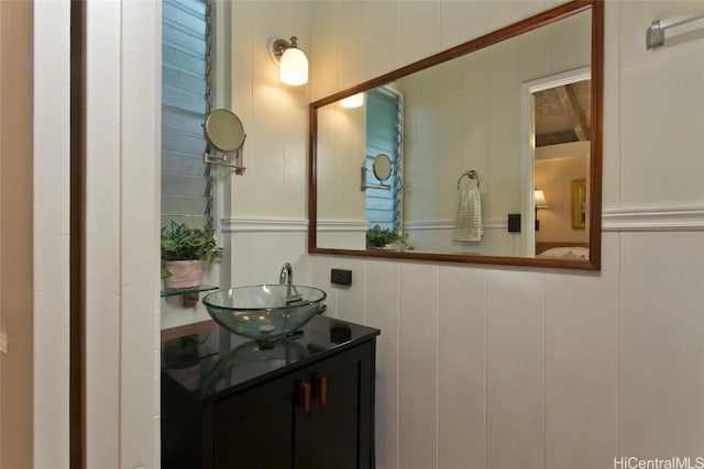 bathroom with vanity and a decorative wall