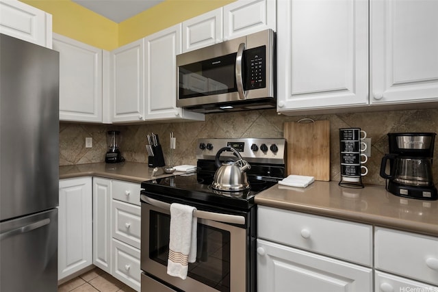 91-2062 Kaioli St Unit 4005, Ewa Beach, HI 96706 - kitchen with appliances with stainless steel finishes, white cabinetry, and light countertops