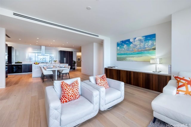 living room with recessed lighting and light wood-style floors