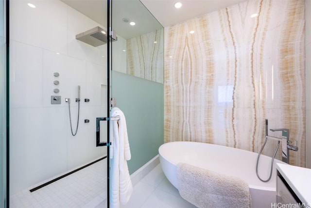 bathroom with recessed lighting, vanity, a freestanding tub, walk in shower, and tile patterned floors