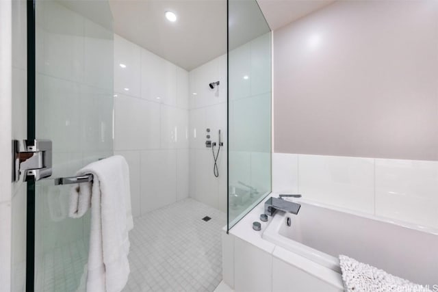 bathroom featuring a garden tub and a walk in shower