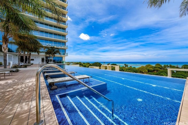 view of swimming pool featuring a water view