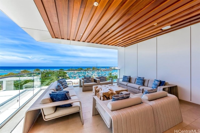 balcony with a water view and an outdoor living space