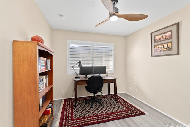 office with baseboards, wood finished floors, and ceiling fan