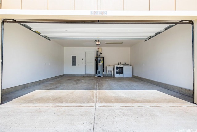 garage with electric panel, sink, electric water heater, and washer and clothes dryer