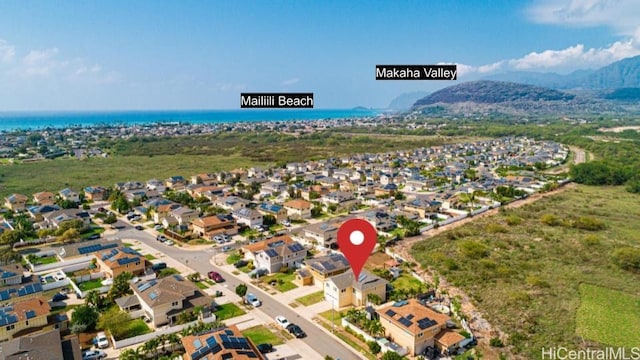 drone / aerial view with a water and mountain view