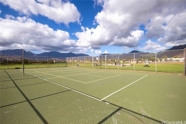 view of tennis court featuring a mountain view