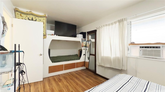 bedroom featuring cooling unit and hardwood / wood-style flooring