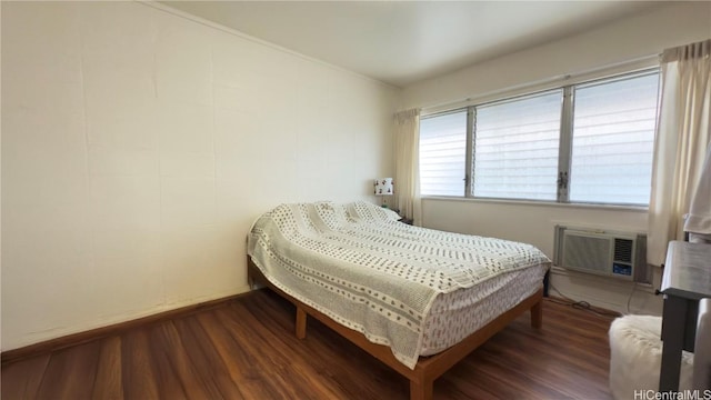 bedroom with dark hardwood / wood-style floors